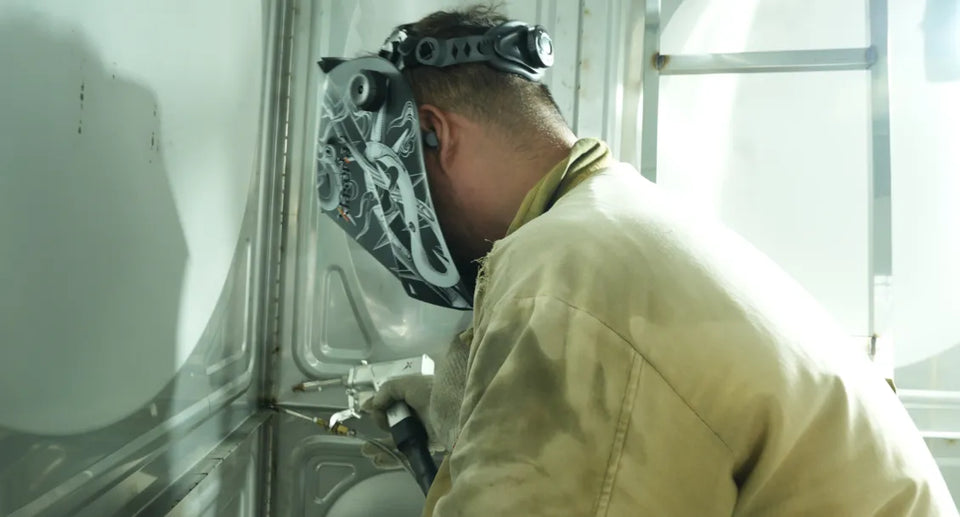 Workers wearing helmets with laser welding