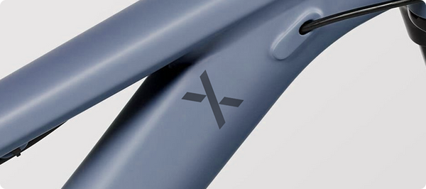 Engraving X icons on titanium bicycles